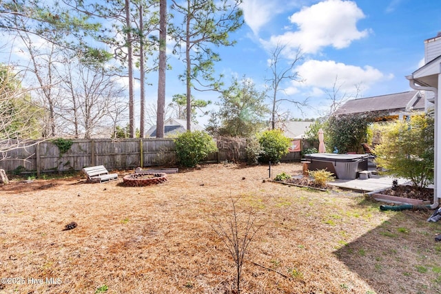 view of yard with a hot tub and a fenced backyard