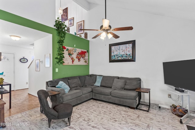 living room with baseboards, high vaulted ceiling, and a ceiling fan