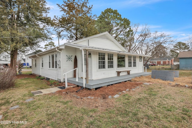 view of front of home with a front yard and fence