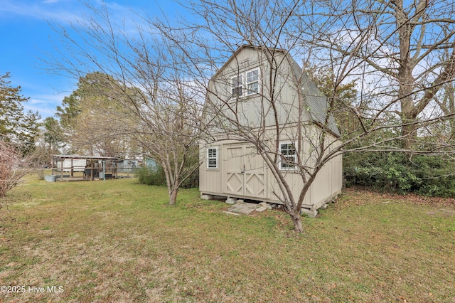 view of property exterior with an outbuilding, a yard, and a shed