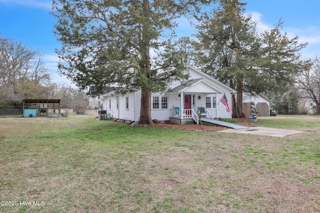 bungalow-style house with a front yard and cooling unit