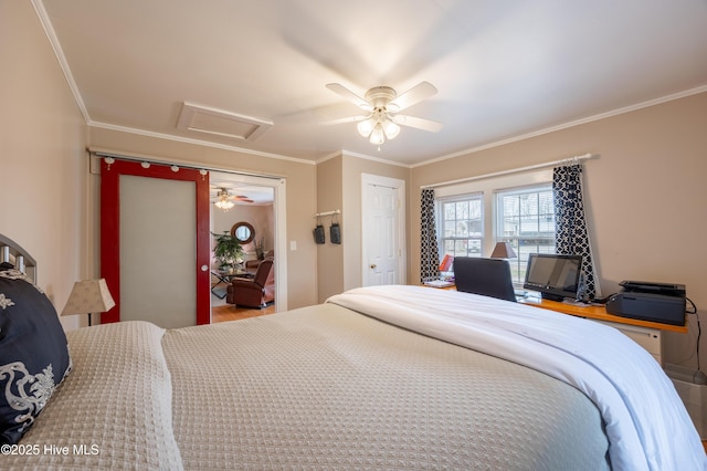 bedroom featuring ceiling fan, attic access, and ornamental molding