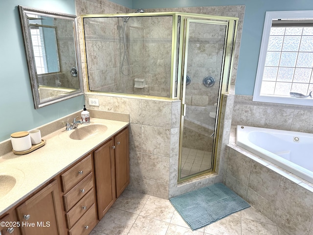 full bathroom with double vanity, a stall shower, a garden tub, tile patterned flooring, and a sink