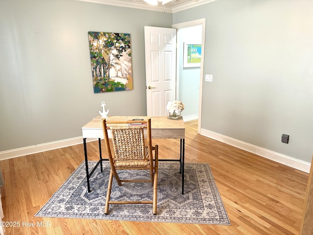 office area with ornamental molding, baseboards, and wood finished floors