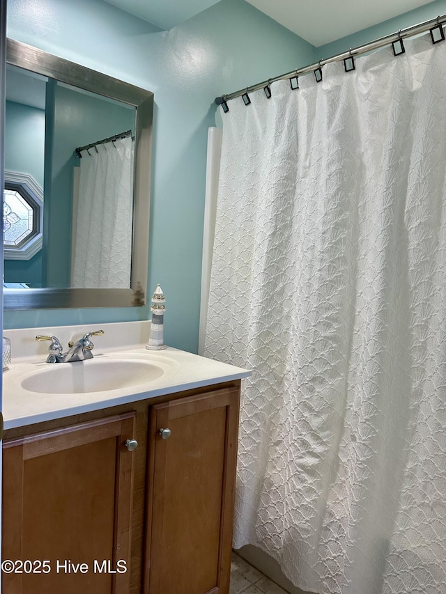 full bath with a shower with shower curtain and vanity