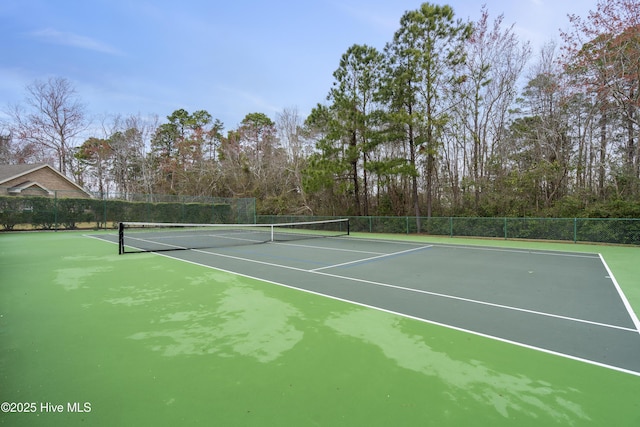 view of tennis court featuring fence