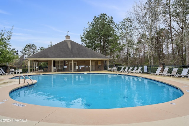 pool featuring a patio and fence