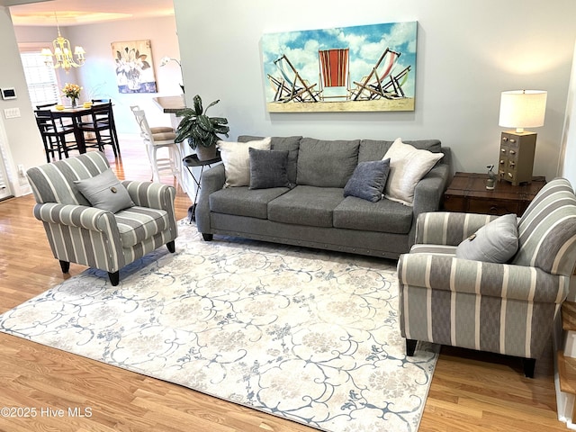 living area with an inviting chandelier and wood finished floors