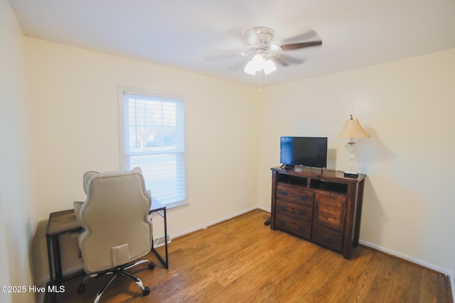 home office with ceiling fan, wood finished floors, and baseboards