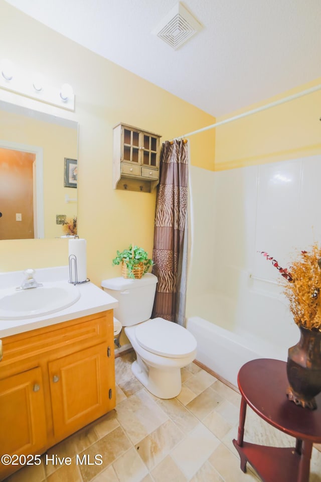 bathroom featuring toilet, shower / tub combo, vanity, and visible vents