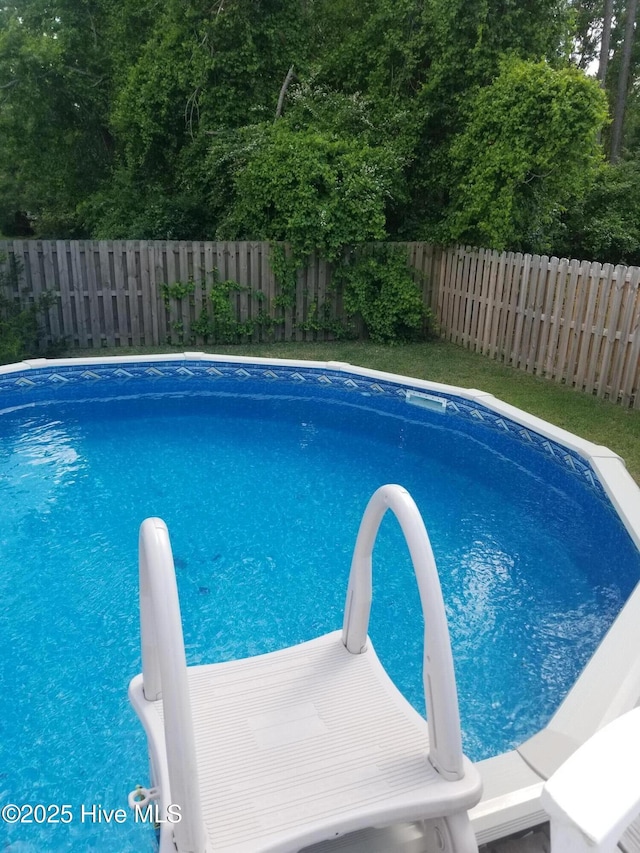 view of pool with a fenced backyard and a fenced in pool