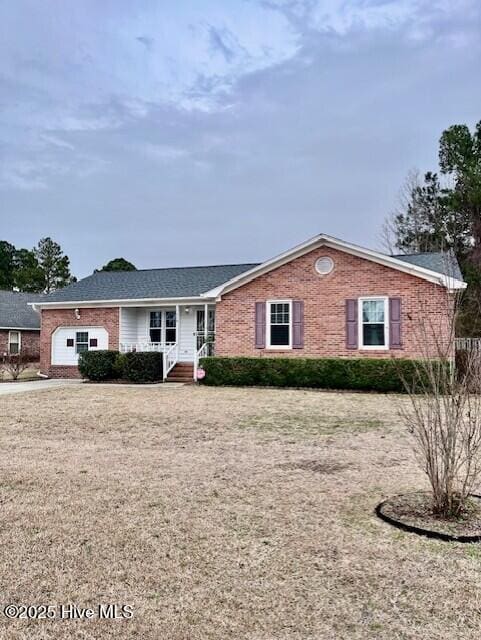 single story home featuring brick siding