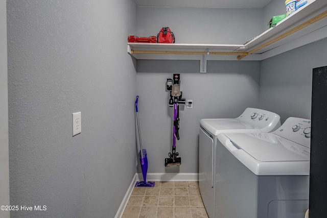 laundry room featuring laundry area, light tile patterned floors, baseboards, and washer and clothes dryer