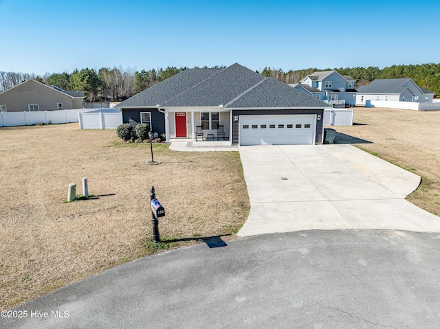 ranch-style home featuring a garage, fence, concrete driveway, roof with shingles, and a front lawn