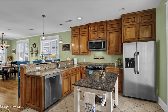 kitchen featuring ornamental molding, brown cabinets, a peninsula, stainless steel appliances, and a sink