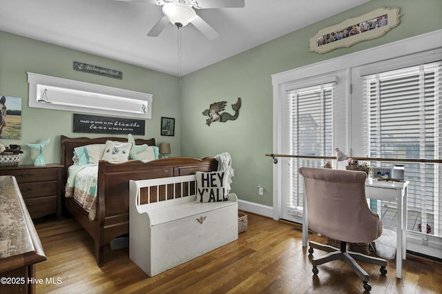 bedroom featuring ceiling fan, baseboards, and wood finished floors