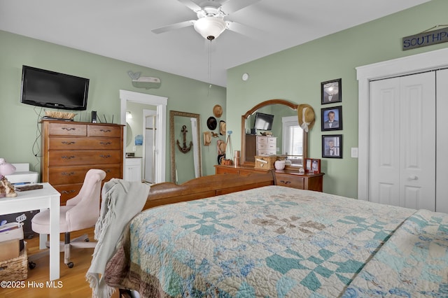 bedroom featuring ceiling fan, a closet, connected bathroom, and wood finished floors