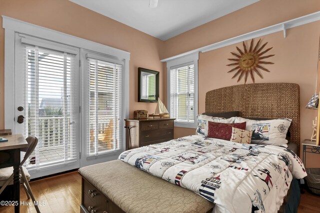 bedroom with wood finished floors and access to outside