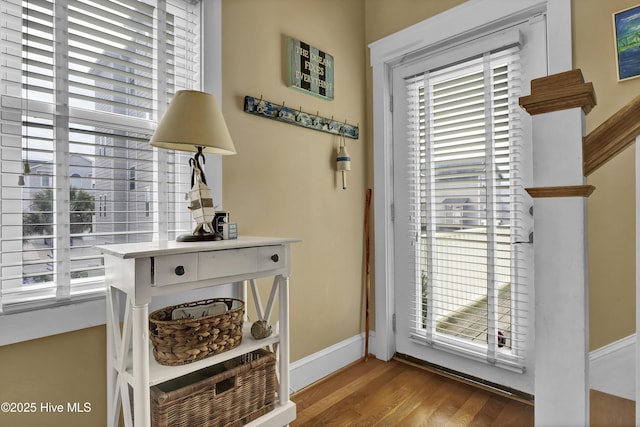 entryway with baseboards and wood finished floors