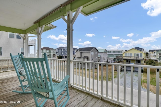 wooden terrace with a residential view