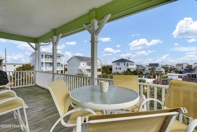 deck with a residential view and outdoor dining area