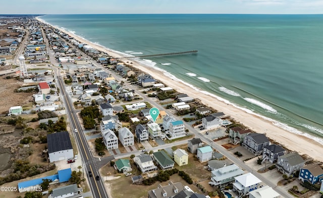 drone / aerial view with a beach view and a water view