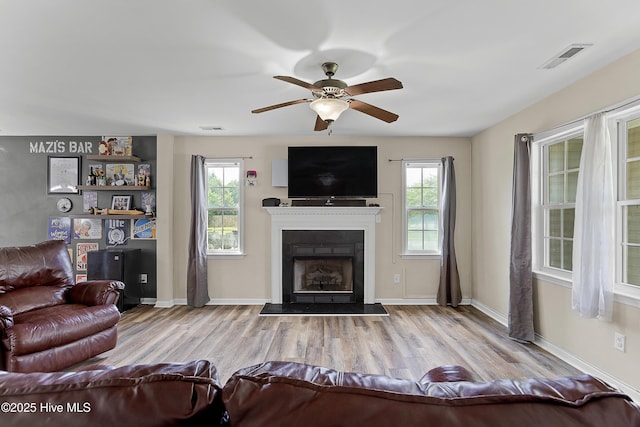 4000 W T Whitehead Dr, Jacksonville, NC 28546 - living area with ceiling fan, healthy amount of natural light, and wood finished floors