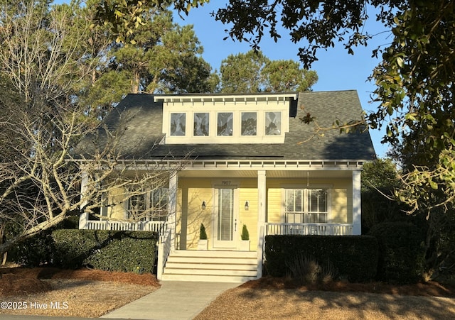 view of front of home with a porch and roof with shingles