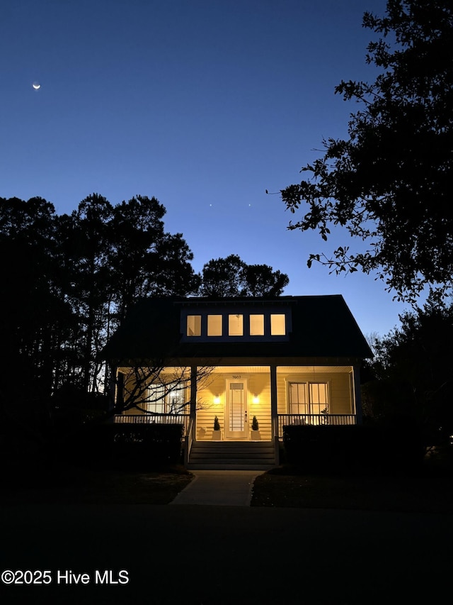 rear view of property with a porch