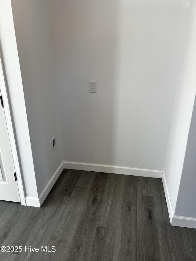 washroom with hookup for an electric dryer, baseboards, and wood finished floors