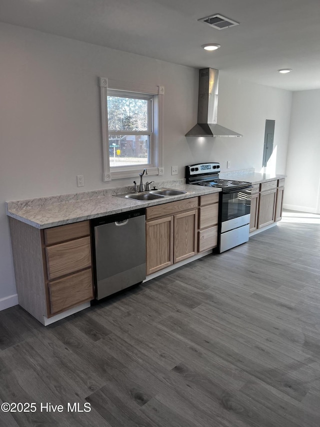 kitchen with a sink, visible vents, wall chimney range hood, appliances with stainless steel finishes, and dark wood-style floors