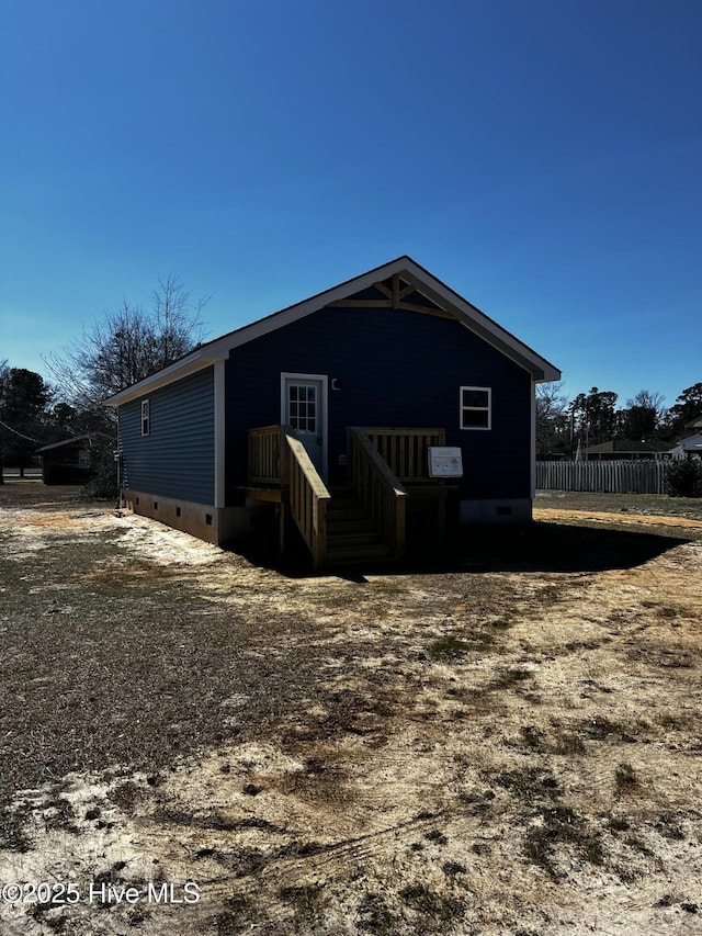 exterior space featuring crawl space and fence