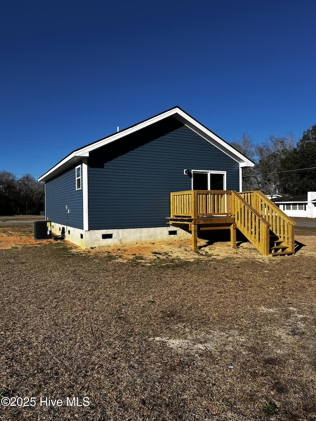 view of home's exterior with crawl space and central AC