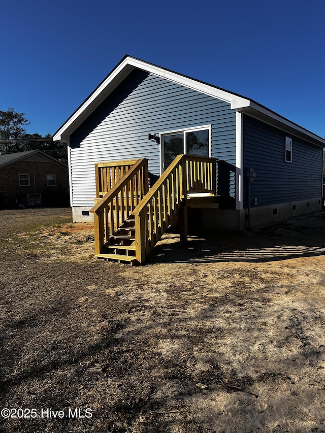 back of house featuring crawl space