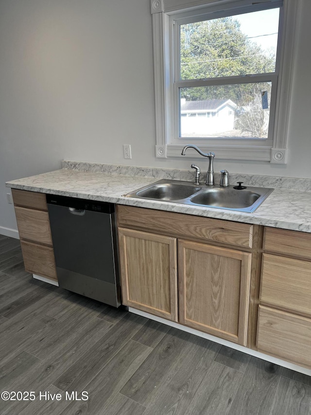 kitchen featuring dark wood-type flooring, light countertops, a sink, and stainless steel dishwasher