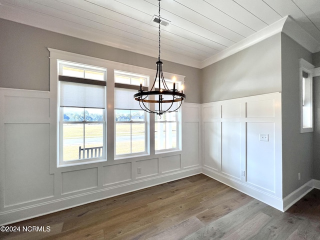 unfurnished dining area featuring wood ceiling, visible vents, a decorative wall, and dark wood-style flooring