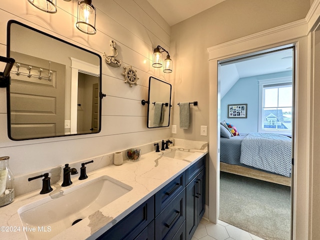 ensuite bathroom featuring double vanity, ensuite bath, and a sink