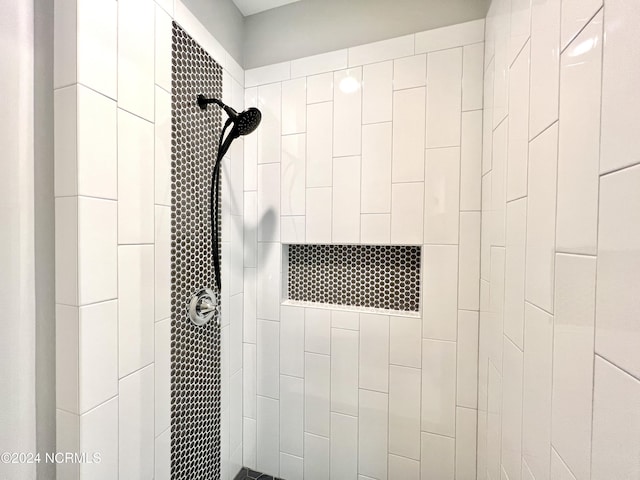 full bath with a tile shower