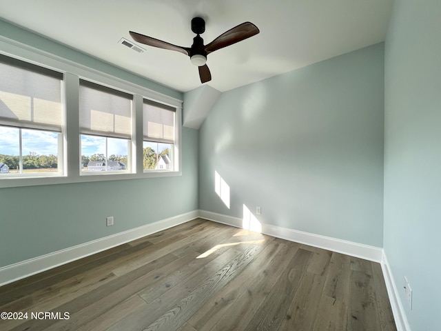 spare room with visible vents, ceiling fan, baseboards, and wood finished floors