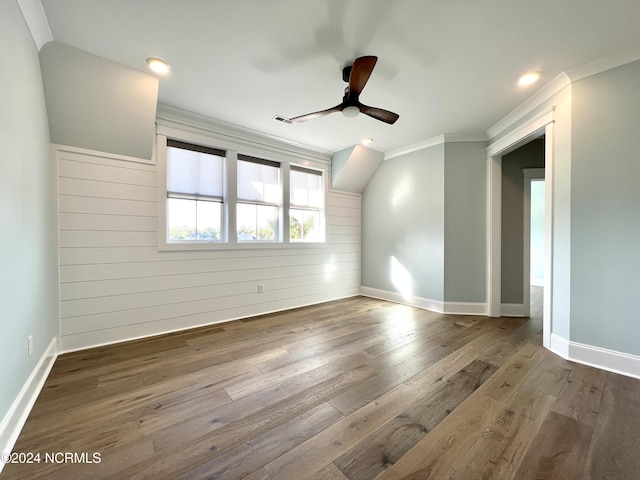 spare room with visible vents, baseboards, wood-type flooring, ceiling fan, and ornamental molding