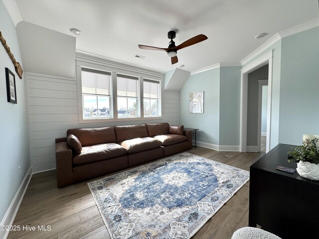 living room featuring a ceiling fan, light wood-type flooring, and crown molding