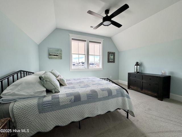 bedroom with lofted ceiling, baseboards, visible vents, and light colored carpet