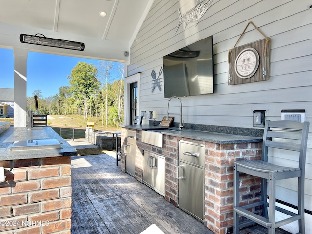 view of patio featuring area for grilling, a sink, and outdoor wet bar