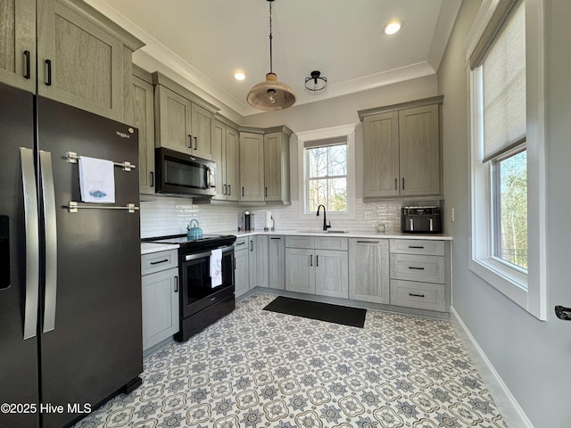 kitchen featuring a sink, baseboards, light countertops, appliances with stainless steel finishes, and backsplash