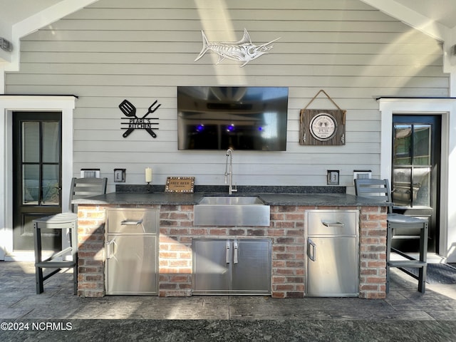 view of patio with area for grilling and a sink