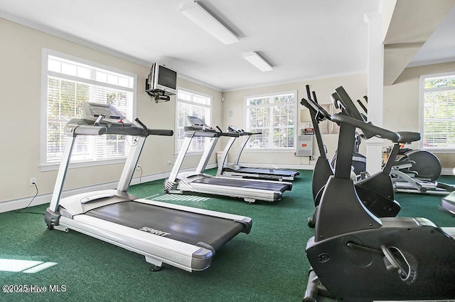 gym with a wealth of natural light, baseboards, and crown molding