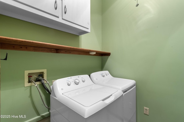 laundry area featuring washing machine and dryer and cabinet space