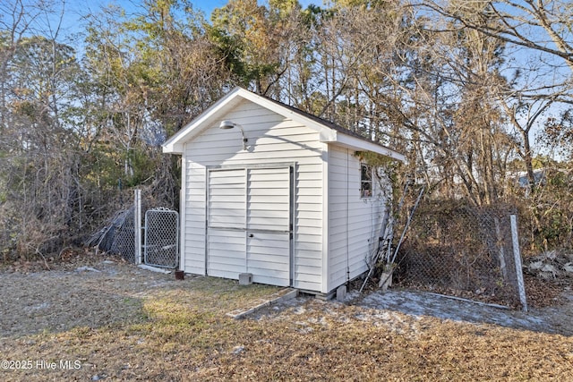 view of shed with a gate and fence