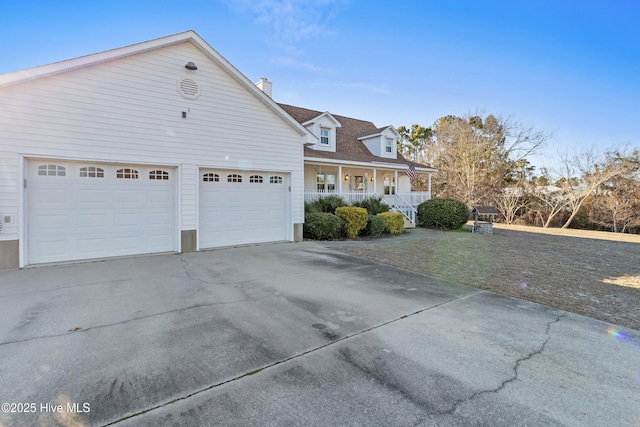 view of front of house with covered porch, driveway, a shingled roof, and a chimney