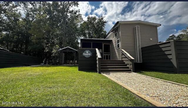 view of yard featuring a sunroom, stairs, and a wooden deck